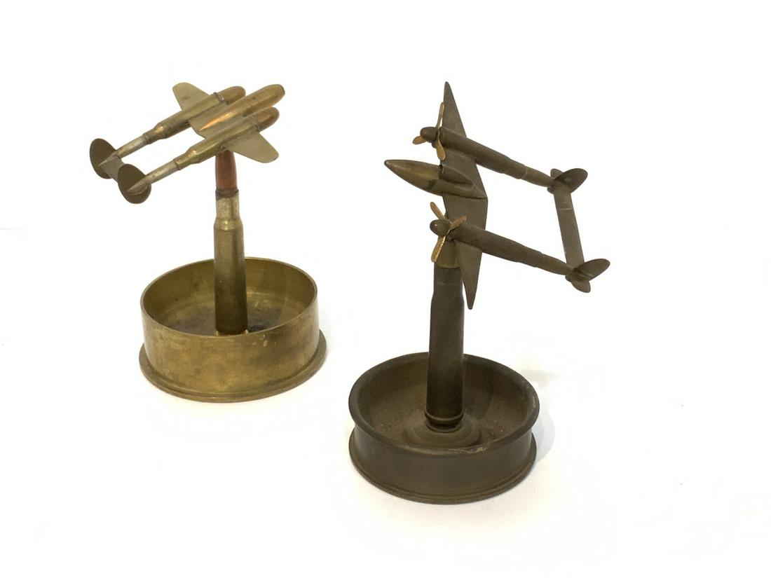 Two (2) Trench Art Ashtrays: Two (2) Trench art trays with spinning airplanes. Dimensions: 7"h X 4 1/2" d