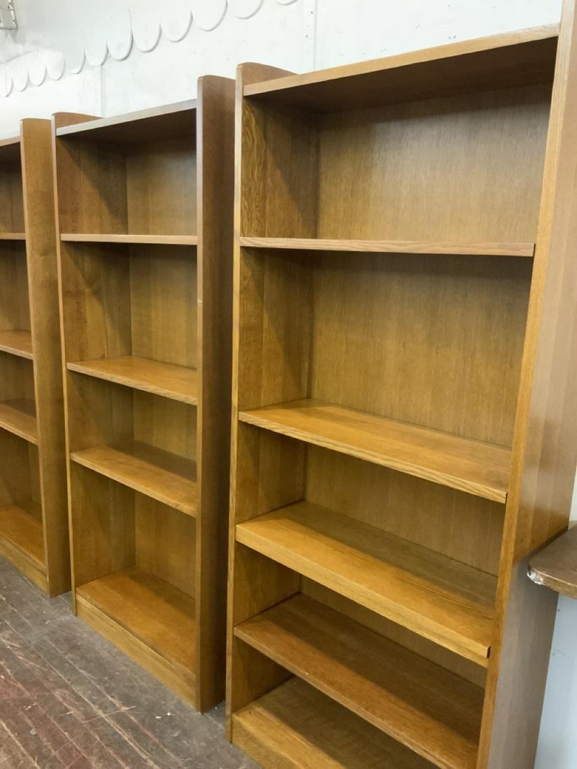 A Pair, Stickley Tall Oak Open Bookcases: A Pair of Stickley Tall Oak Bookcases. Each having one permanent shelf and four adjustable shelves. some metal pegs for shelving missing. Dimensions: 79 1/2" X 34" X 12" Fine condition. Signed on reve