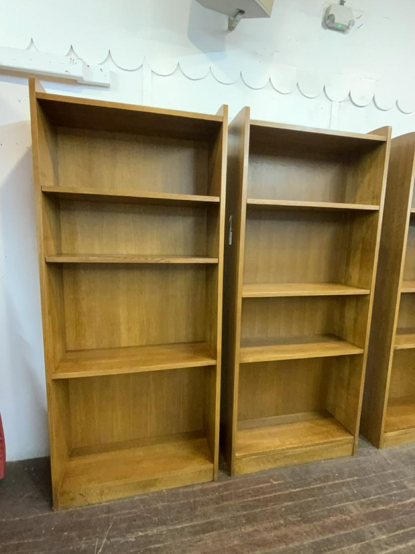 A Pair, Stickley Tall Oak Open Bookcases: A Pair of Stickley Tall Oak Bookcases. Each having one permanent shelf and four adjustable shelves. Some metal pegs for shelving missing. Dimensions: 79 1/2" X 34" X 12" Fine condition. Signed on reve