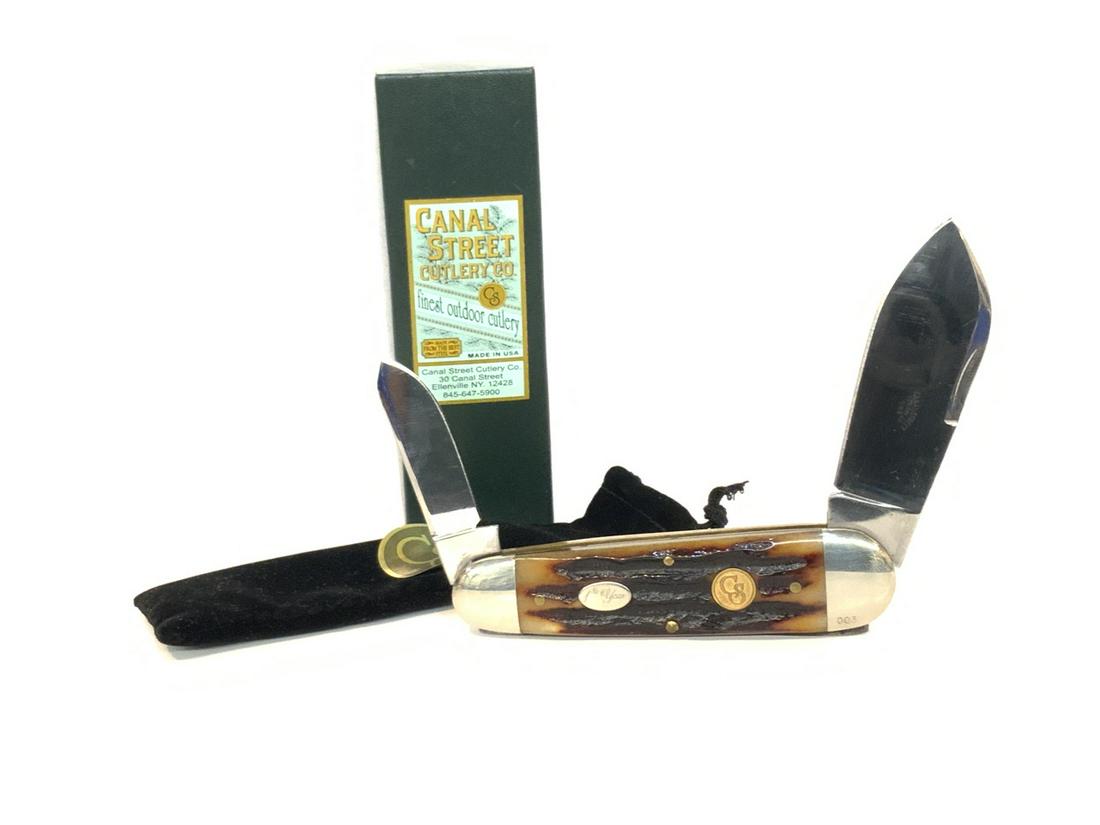 Canal Street Cutlery, Swing Guard Lock Back Pocket: Canal Street Cutlery Company, Ellenville, New York Swing Guard Lock Back Pocket Knife. c.2006 Dimensions: 4 1/2" lengthOriginal box with papers. Fine condition. Collector quality, unused. Dark Amber S