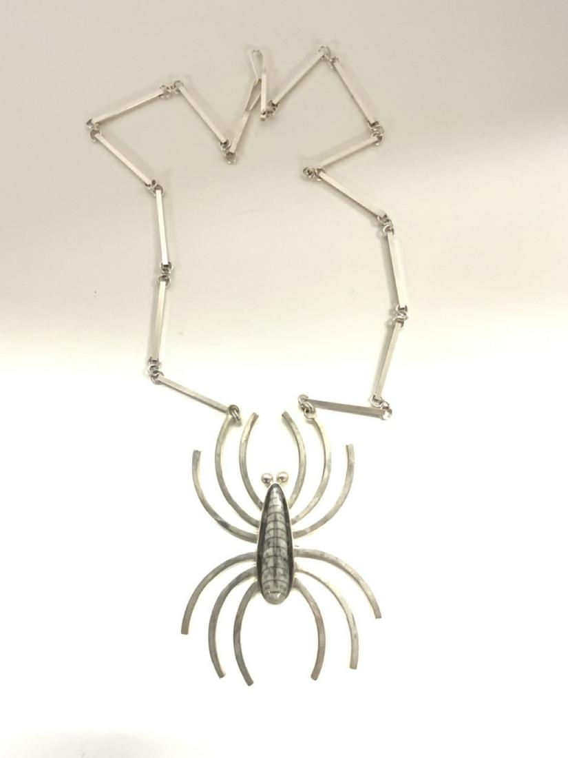 Aaron Rubenstein Modernist Spider Necklace, Sterling: Aaron Rubenstein Fossil Spider Necklace. Sterling silver. Dimensions: 4" X 2 1/2" (Spider) and 15 1/4" drop necklace Total weight: 1.7393 troy ounces Large carved dark oak pier mirror with matching be