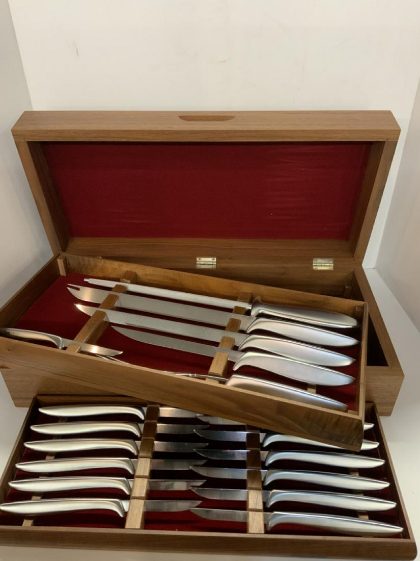 Extensive Top Shelf Gerber Knife Set: A boxed Gerber knife set serving for twelve plus carving pieces. Housed in a teakwood case.