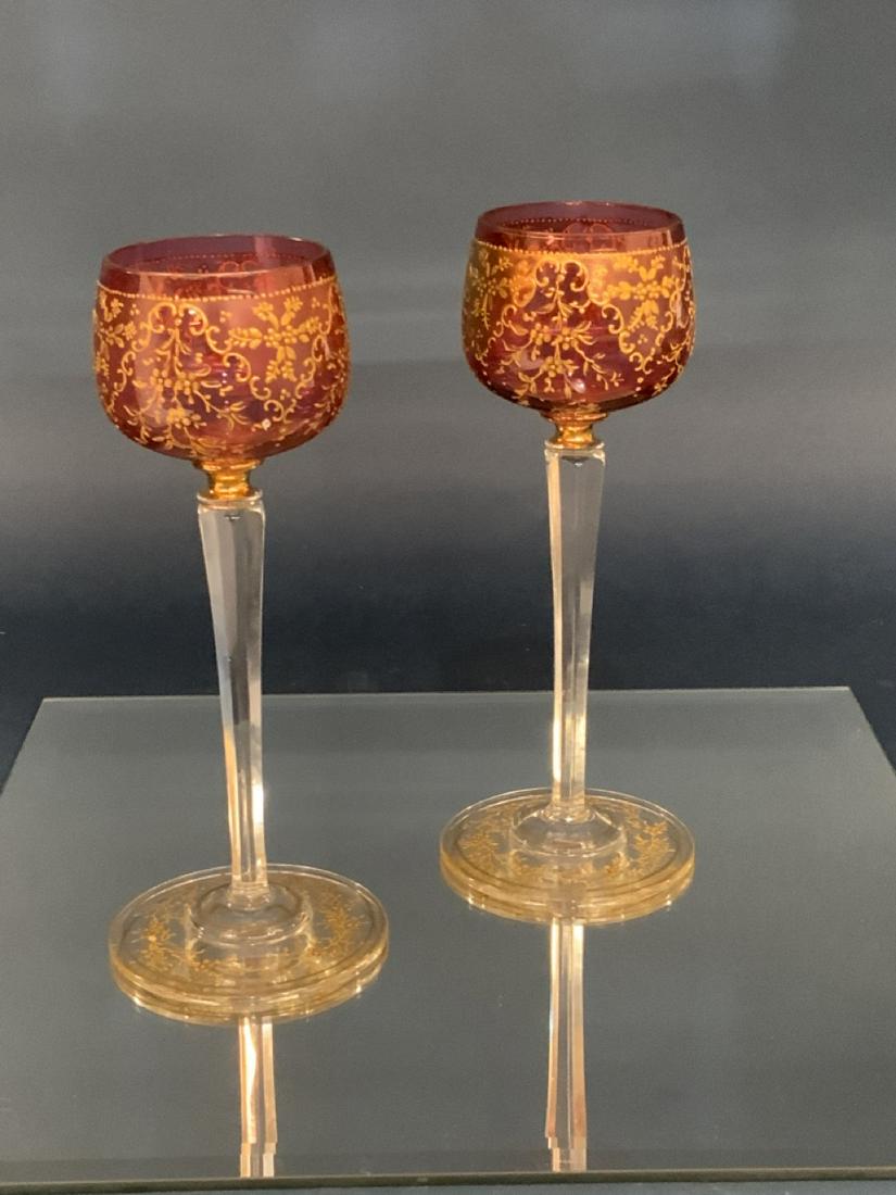 Moser Glass Goblets: A pair of Moser glass cranberry and gold decorated stems. Dimesions: 7 3/4" X 3 1/4"