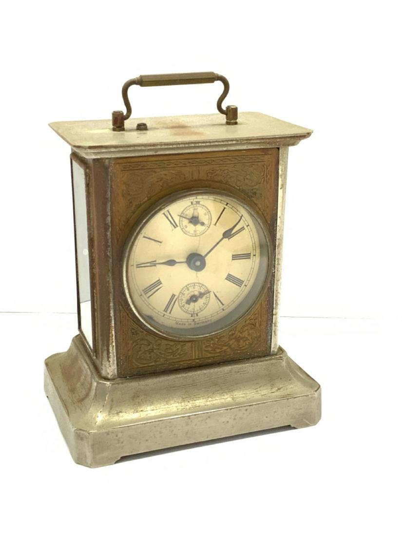 Musical German Carraige Clock: Musical Carriage Clock. Made in Germany. Include later key. Winds but does not keep time. As is. Has a swiss cylinder musical box at base. Dimensions: 7 1/2" X 5 1/4" X 4"