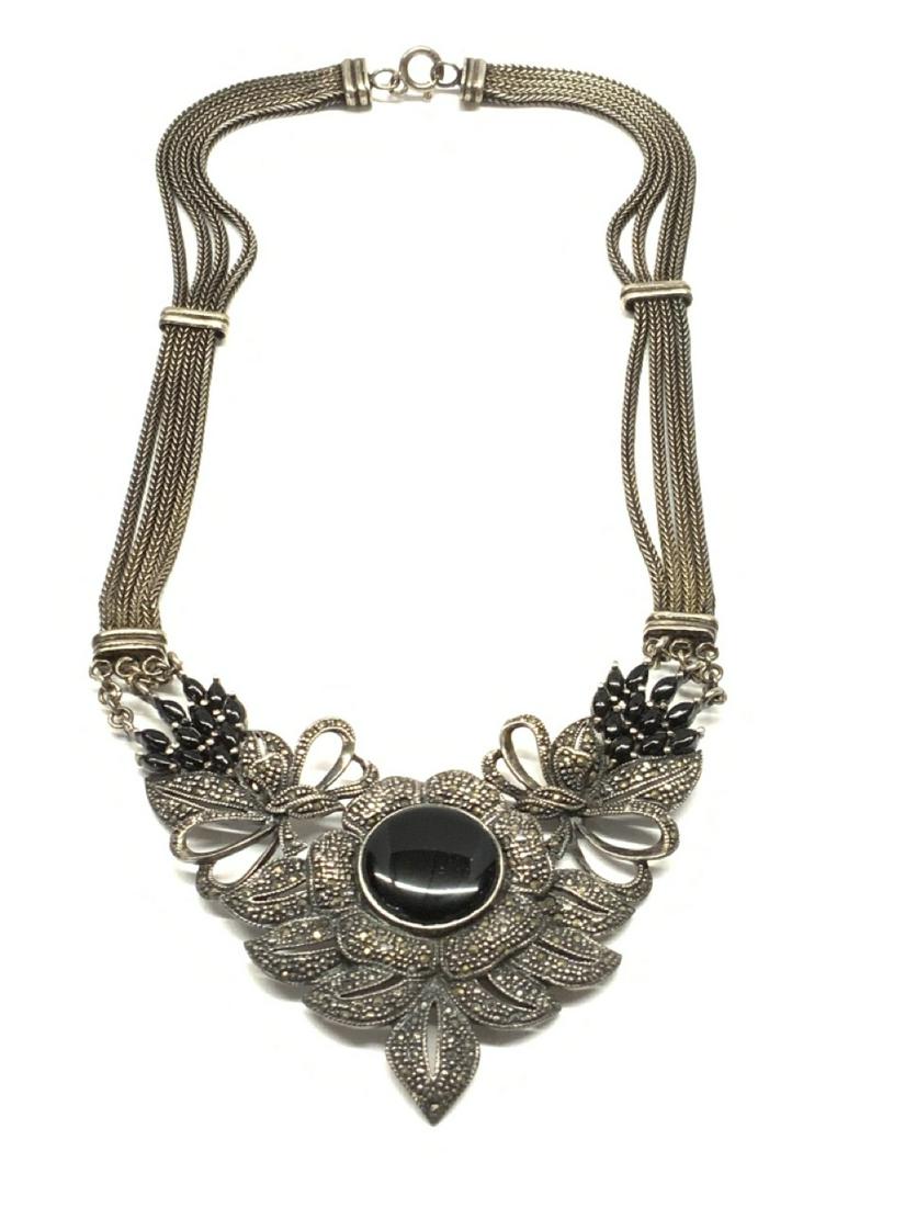 Sterling Silver Marcasite And Onyx Necklace: Sterling silver marcasite and onyx necklace. Dimensions: 8 1/2" drop