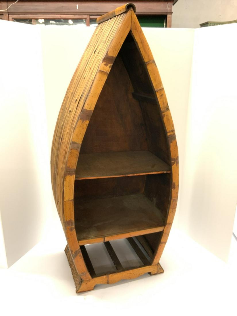 Rattan Boat Shelf: Rattan decorative boat shelf. Probably had a drawer at base which is no longer there. Dimensions: 37"h X 16" X 11"
