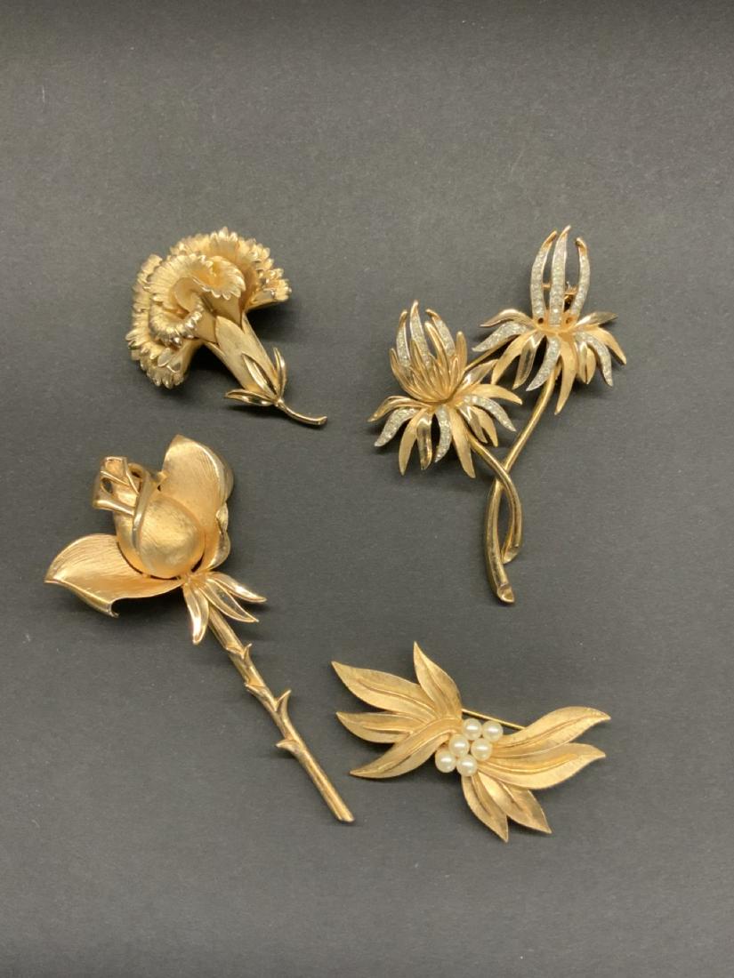 Four (4) Vintage Trifari Goldtone Pins: A grouping of four (4) vintage 50's/60's Trifari pins. Dimensions: 3 1/2" X 2 1/4" largest.