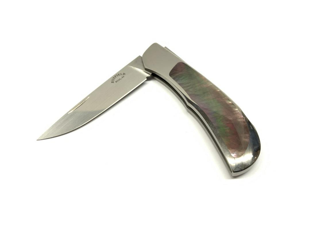 John Busfield Black Mother Of Pearl Folding Knife: John Busfield, Mesa AZ black mother of pearl folding knife. Dimensions: 2 3/4" blade and 6" overall. Provenance: Single owner estate collection. Family wishes to see this collection off to collector's