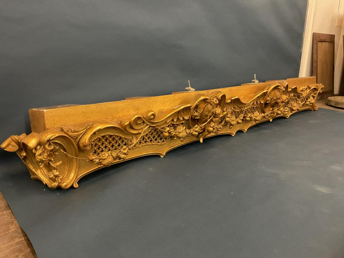 American Gilt Wood 19th c. Window Cornice Architectural.: American carved gilt wood frame and gesso arched window cornice Baroque pierced crest with putti and fruit garland. Matching mantel mirror lot number 171-172.Dimension: 11” x 101” x 14 1/4