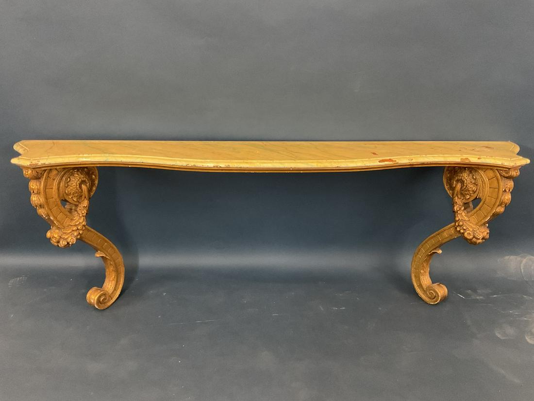 19th c GIlt Wood Console Table: A large foyer entry gilt wood console table with faux marble top. Some damage present on table. See pictures for review.Dimension: 26 1/4” x 79” x 14 1/2”