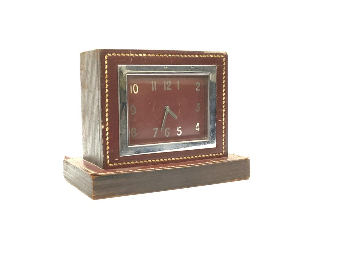 Art Deco Hermes Paris Desk Clock: An Art Deco period Hermes French desk clock. A square clock with chrome, wood and covered with oxblood red stitched leather. Dimensions: 4 3/4” X 6” X 3 1/2” and face is 3” X 3