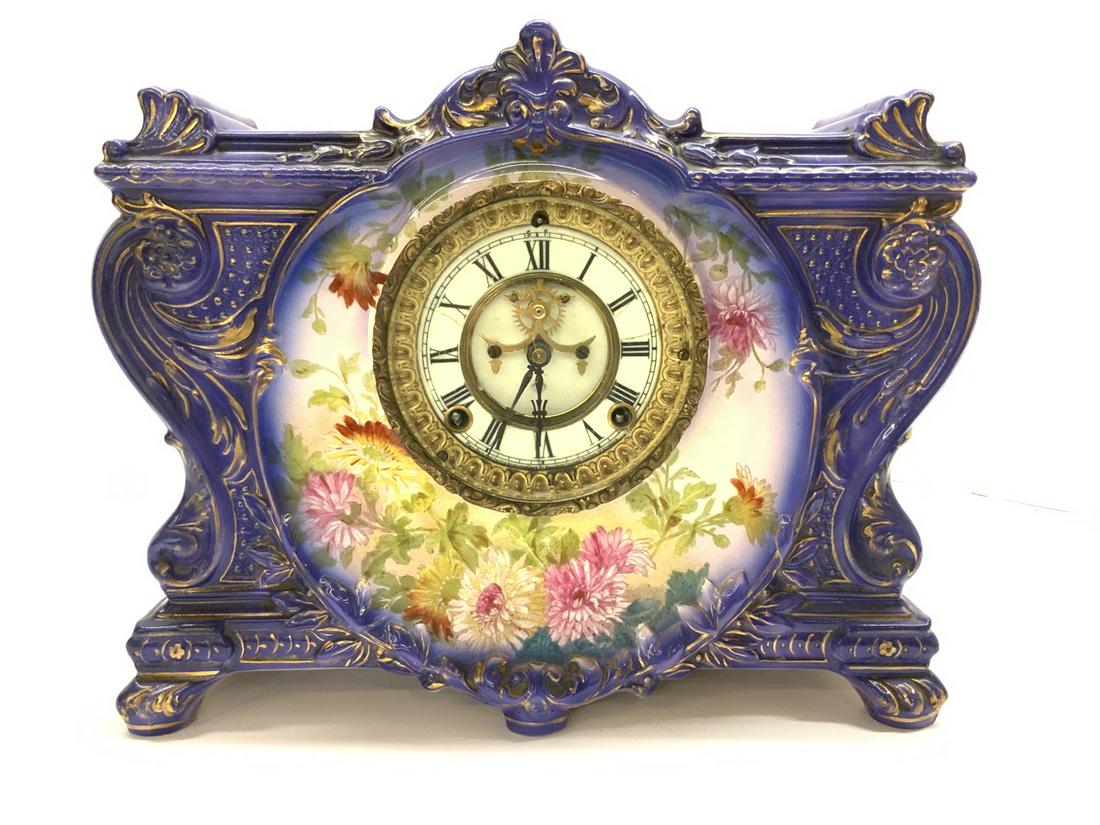 Ansonia Mantle Clock: An Ansonia mantel clock with Royal Bonn German porcelain case. Signed reverse. Appearing to be all original works and pendulum. Dimensions: 11 1/2” X 14 1/2” X 5”