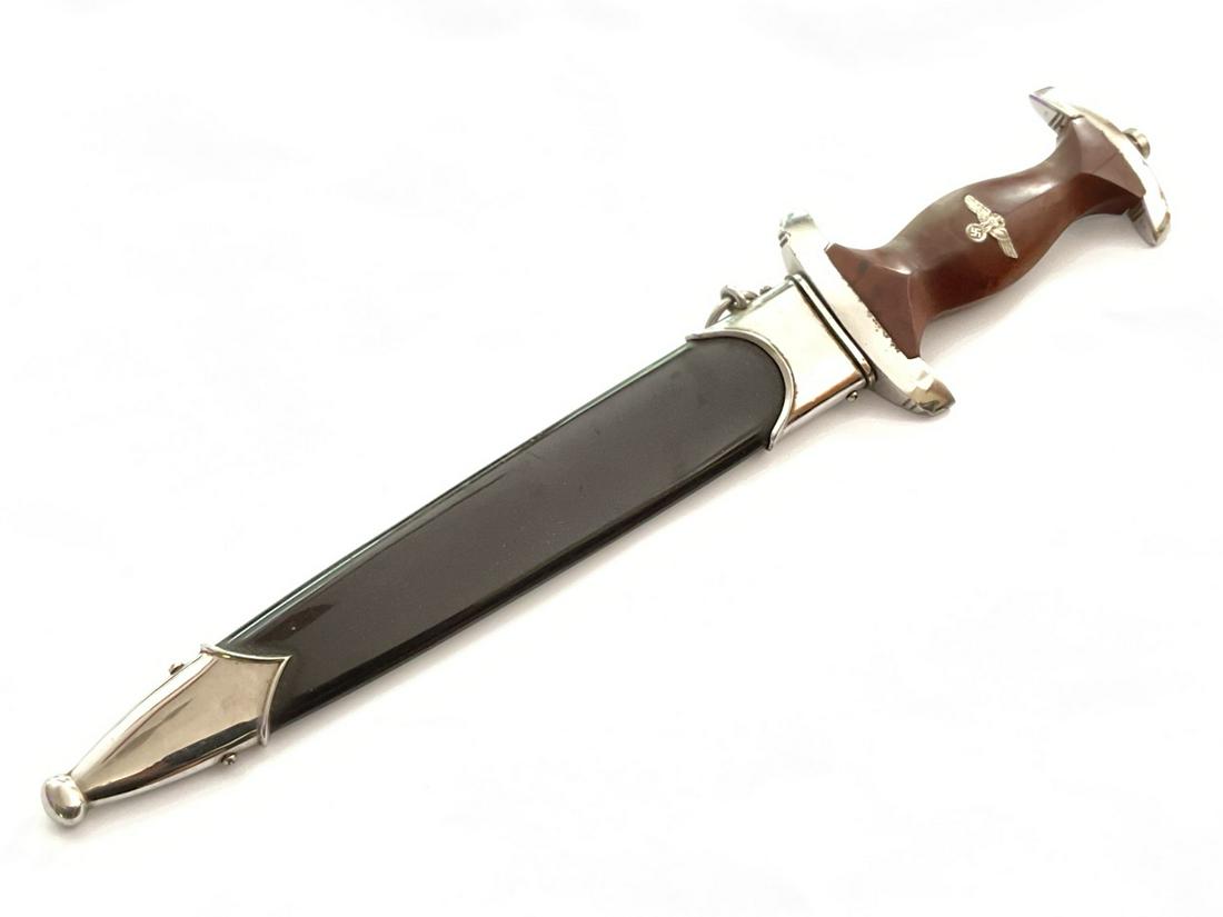 German WWII Dagger: German WWII Dagger. Cracking noted in handle. Please see photograph preview or call. Dimensions: 13 1/2”