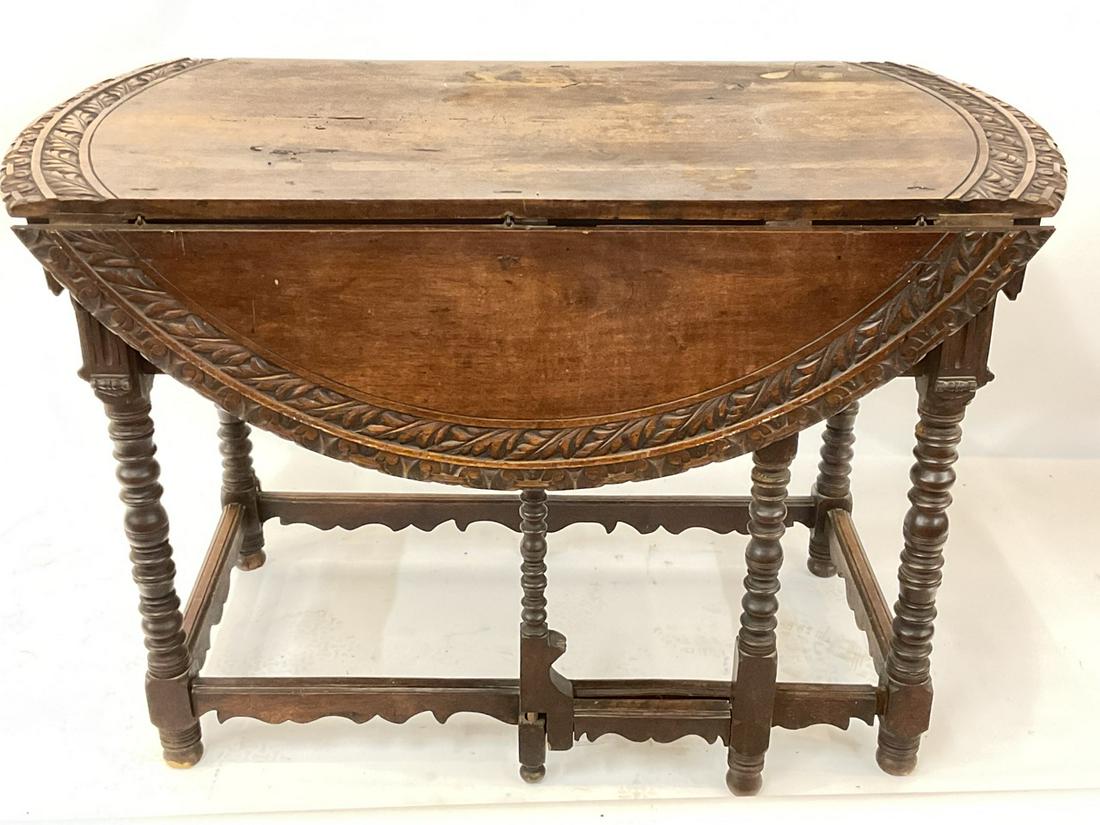 Carved Drop Leaf French Country Gateleg Table: A fine carved drop leaf table. Probaby French wine country, 19th century. Dimensions: 31” x 47” x 22 1/2” 11 1/4 “ side leaves