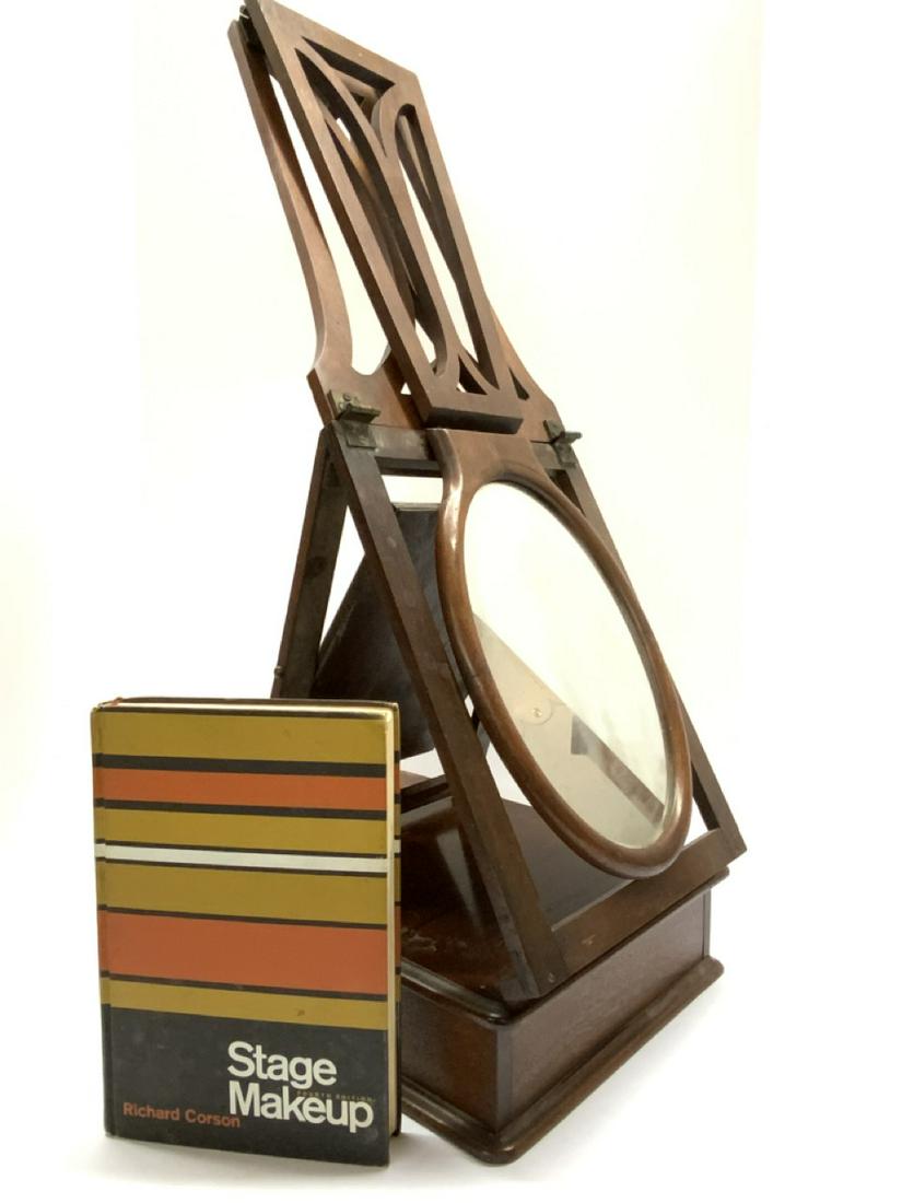 Antique Actor's Stage Makeup Mirror: An antique actor's stage makeup mirror. Similar in style to a shaving mirror this travel makeup mirr folds up for transport. Dimensions: 28” x 14” x 10”