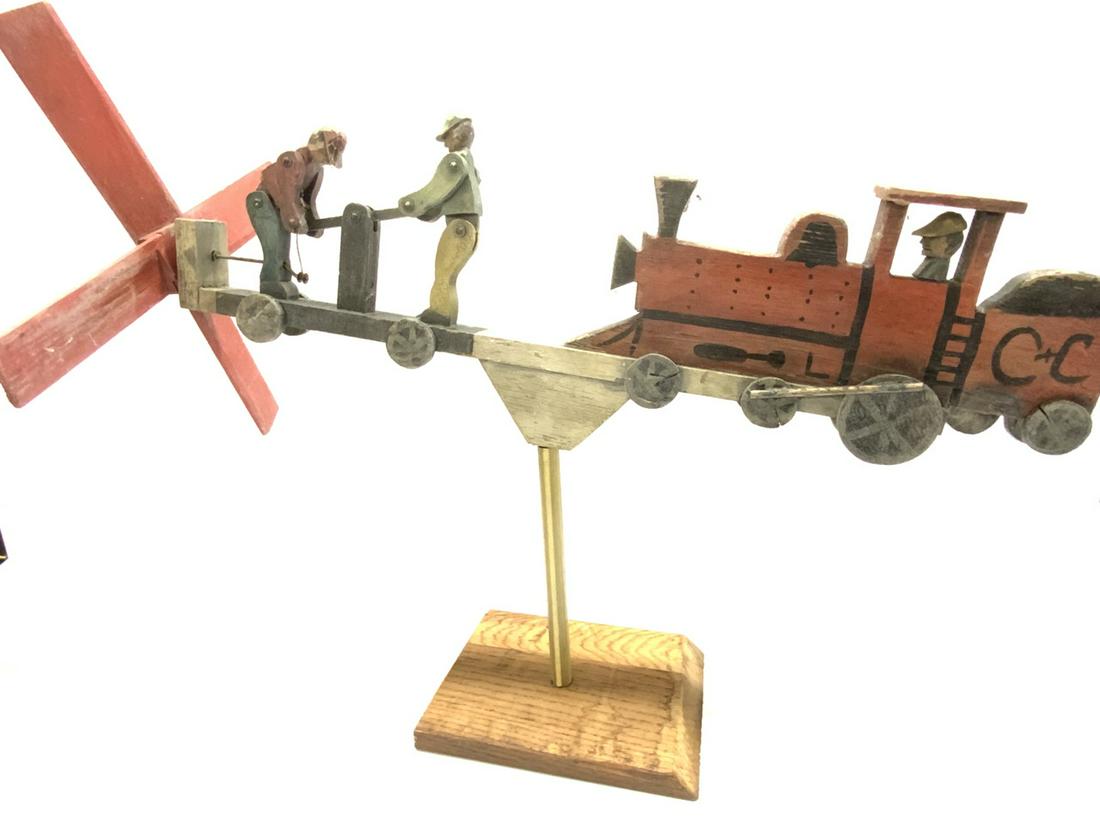 Americana Folk Art Railroad Themed Whirligig: An Americana Folk Art Railroad Themed Whirligig. Some weathering from age. Overall very good. Dimensions: 10” x 32”