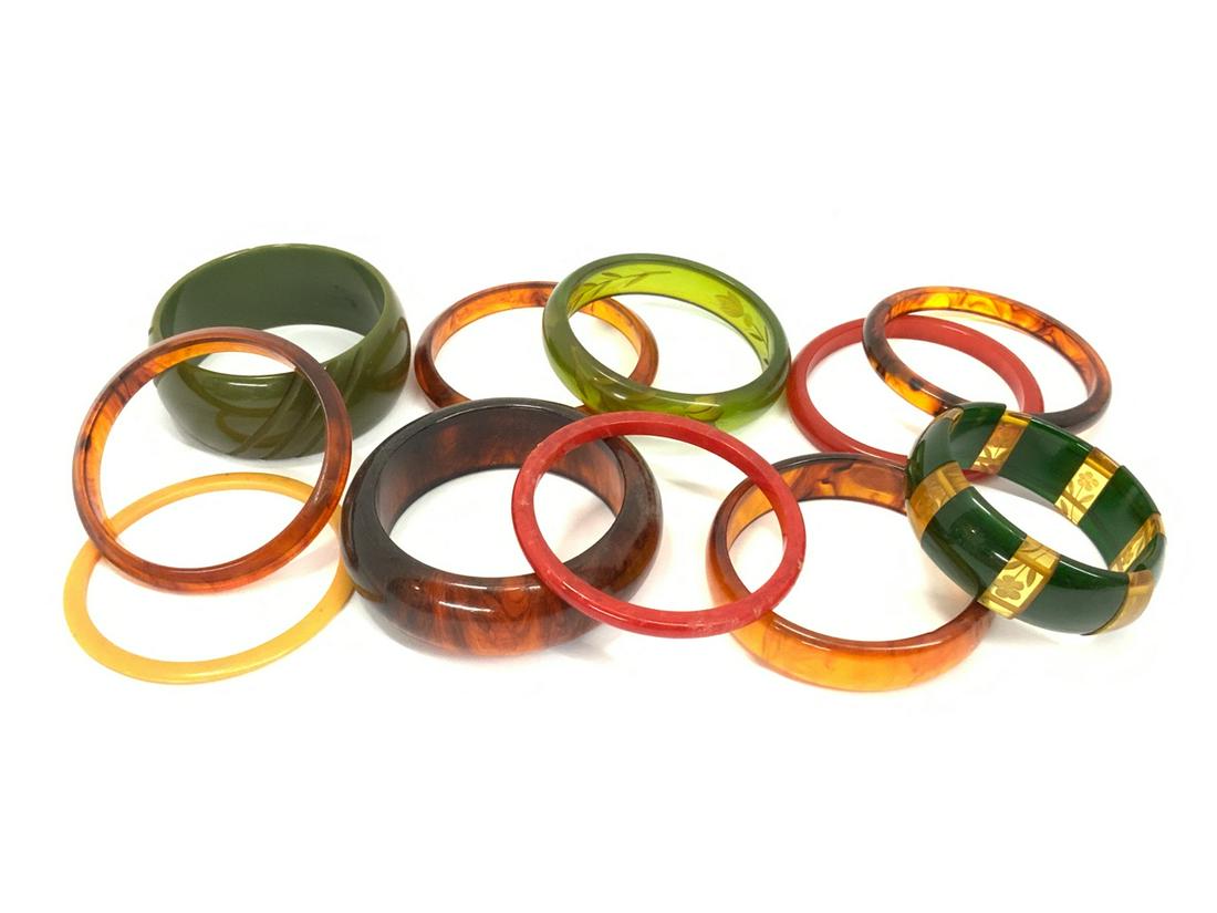 Compiled Vintage Bakelite, Plastic and Lucite Bangles: Assorted Vintage Bakelite, Plastic and Lucite Bangle Bracelets. As seen in photograph preview. Eleven (11) Pieces total.