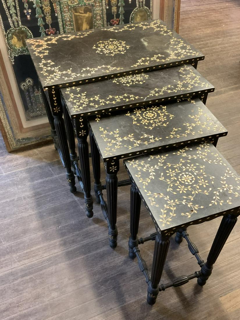 Anglo-Indian Set of Four Nesting Tables: Ebonized wood with bone inlay nesting tables. Set of four in the Anglo-Indian style. Early 20th century. Dimensions: 26" X 27" X 17" and 24" X 12" X 10 3/4" (smallest)