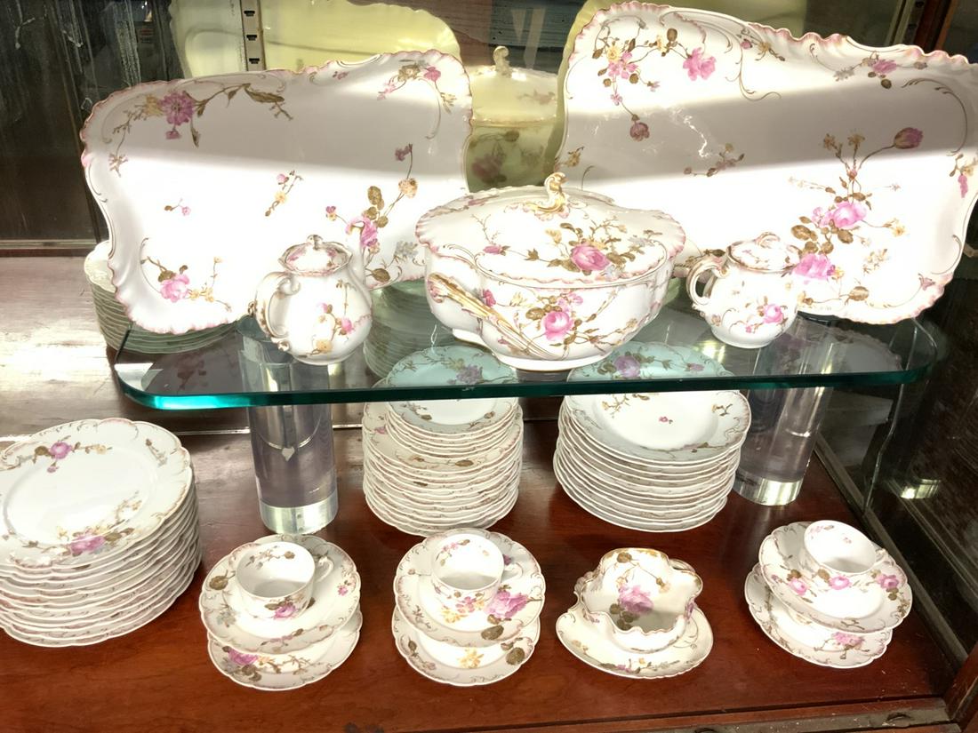 Limoges French Porcelain Service: An incomplete French Limoges porcelain dinner service. As seen in photograph preview. Platters, tureen, plates, cups and saucers etc. Pink rose decoration.