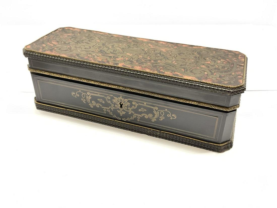 French Boulle And Brass Inlayed Glove Box, 19th century: 19th c. ebonized wood Boulle style with brass inlay. No key present. Signed at top of lock mechanism. Dimensions: 3 1/2" X 10 1/2" X 4"