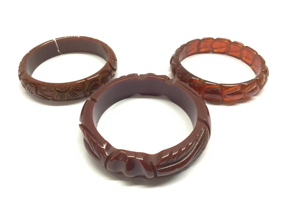 Three (3) Bakelite Bangle Bracelets: Three (3) Bakelite Bangle Bracelets Carved Toffee, Prystal etc. Crack in one toffee bangle noted. See photo