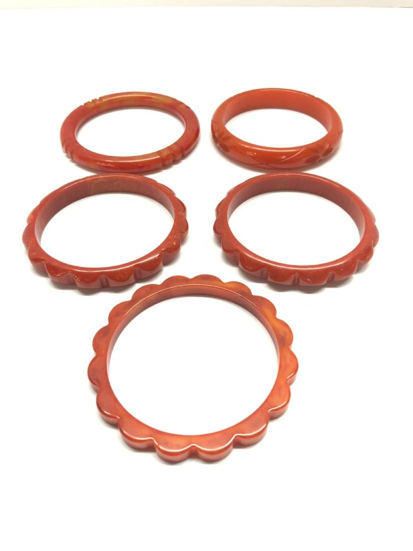 Five (5) Bakelite Bangle Bracelets: Five (5) Bakelite Bangle Bracelets. Tangerine and marbleized tangerine. As seen in photograph preview.