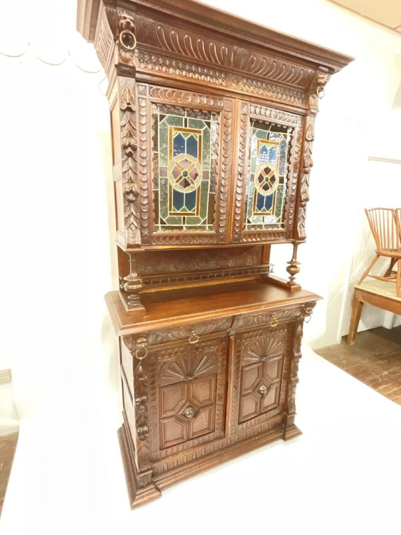 19th c. Carved Baroque Secretaire Cabinet w/ Stained Glass: Heavily Carved European Dark Oak Hutch Cabinet with Jeweled Stain Glass Two Door Glass Panels. Dimensions: 90”h x 47 1/2” x 22”