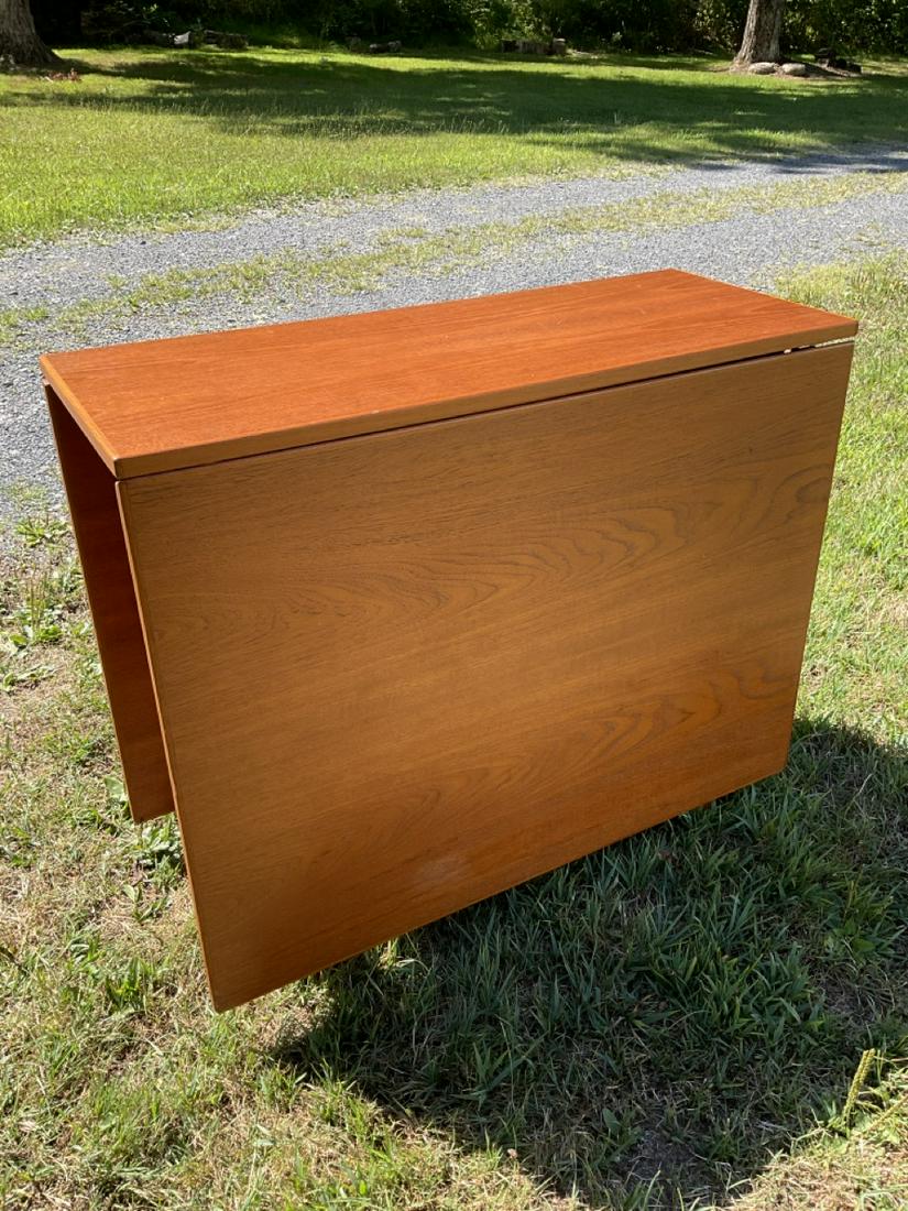 Mid Century Danish Modern Teakwood Drop Leaf Table: Mid Century Danish Modern Teakwood drop leaf table. Dimensions: (closed) 29X 34 1/2 X 13 1/2 (Open) 29X 64X 13 1/2