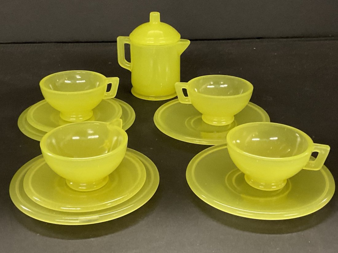 Rare Child's Vaseline Glass Tea Set: A child or doll size vaseline glass play tea set. Includes teapot, four cups, two saucers and four plates. All in excellent condition. Rare service. Dimnesions: 2"-3"