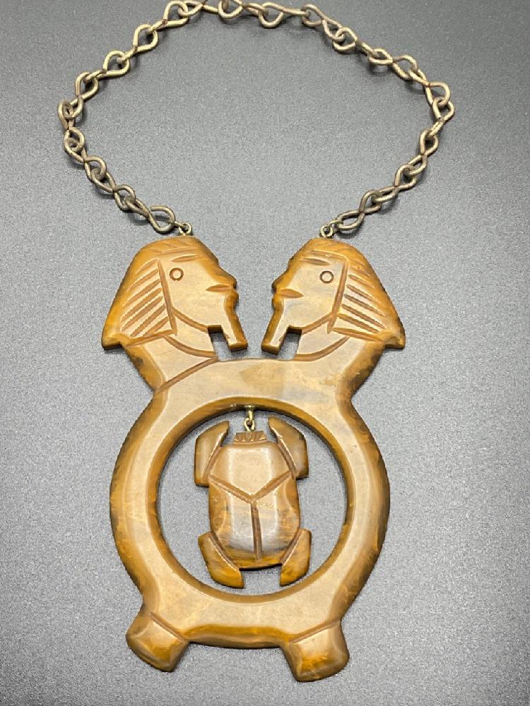 Huge Carved Bakelite Egyptian Necklace: Egyptian Pharaohs and Scarab carved Bakelite Pendant and chain necklace. Dimensions: 9 3/4" drop overall. Pendant is 5" X 3 1/4".