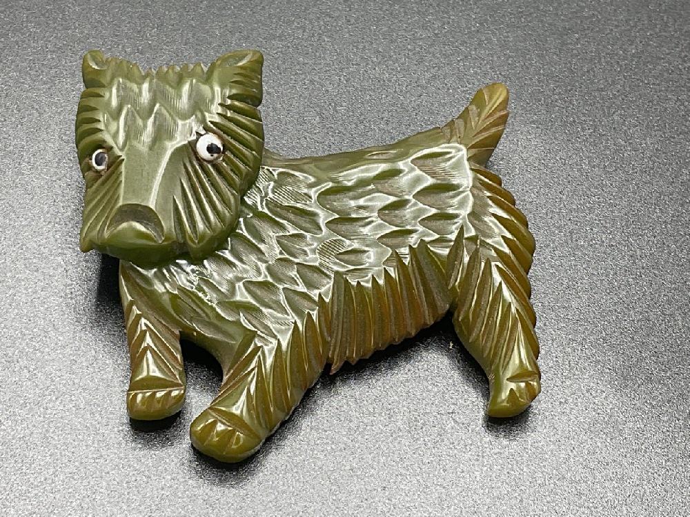 Bakelite Green Carved Dog with Movable Head: Bakelite Green Carved Dog with Movable Head Dimensions: 2 1/4” x 2 1/2”