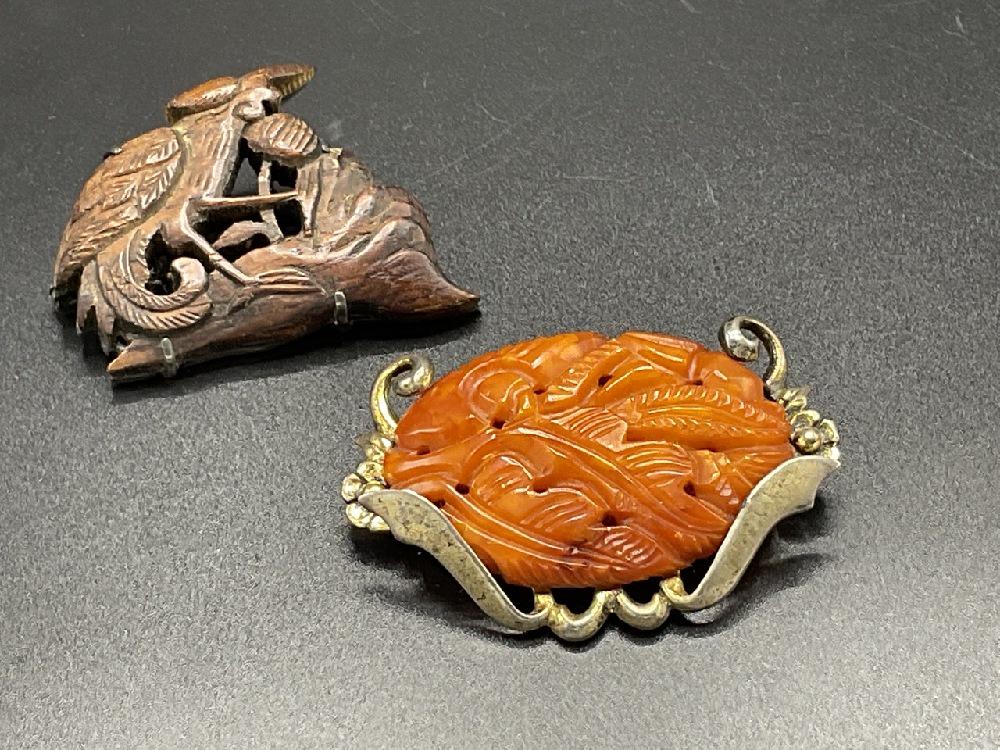 Vintage Chinese Carved Wood And Carved Bakelite Silver Pins: Chinese carved wood pin in sterling silver and sterling silver carved Bakelite pin. Dimensions: 1 1/2" X 2"