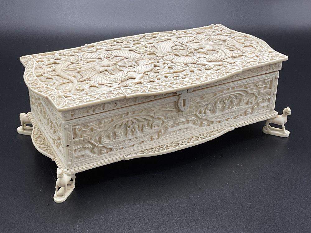 Heavily Carved Bone Chinese Box: A heavily carved Chinese faux ivory or bone footed jewelry box. Stress cracks noted. Dimensions 3 1/2” x 9” x 5”