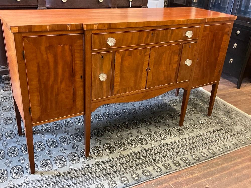 Federal Mahogany Sideboard: A Federal mahogany sideboard with sandwich glass pulls. Veneer loss noted. Please see photograph preview. Dimensions: 41” x 73” x 21 1/2”