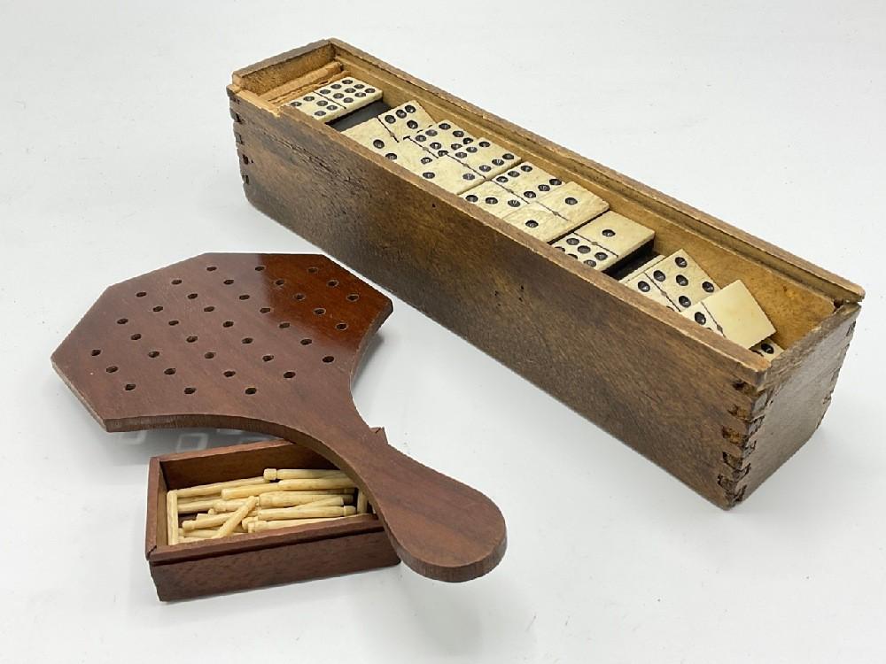 19th century Solitaire Peg Game and Dominoes: 19th c. Solitaire peg game and assorted Ebony and bone dominoes. As seen in photograph preview.