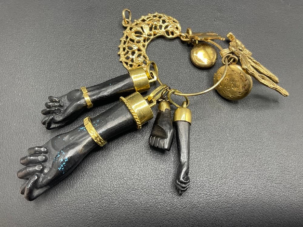 Four (4) Blackamoor Ebonized Wood Hands: Four (4) Blackamoor ebonized hand charm pendants with 18k gold. Gold lockets, one not gold and bail.