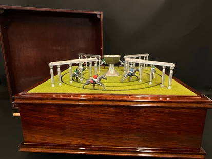Abercrombie and Fitch Mechanical Horse Race Game: Unusual Abercrombie and Fitch Mechanical Horse Race Game. Winds up similiar to a disc music box. Comes with lid. Condition: Some horses are missing limbs. Most if not all loose pieces are accounted fo