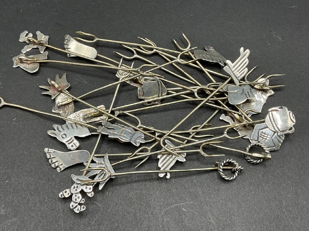 24 Qty Vintage Taxco Sterling Silver hors d’oeuvres Forks: Twenty -Four (24) Sterling Silver hors d'oeuvres forks. Fun Festive Designs. Taxco Mexico. Totalw weight: 1.33 troy ounces. Dimensions: 3" length.