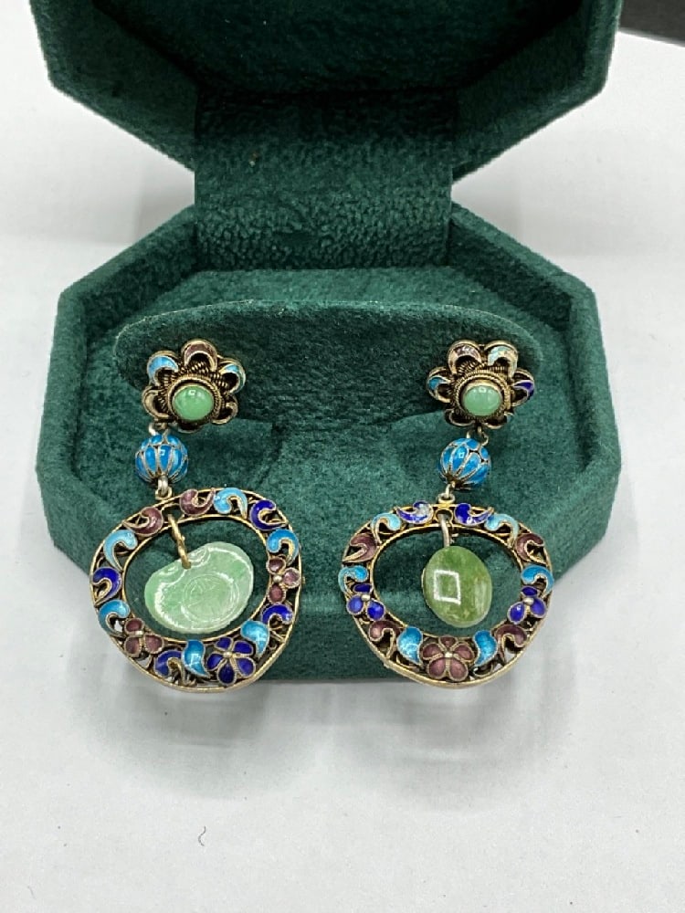 Vintage Champleve Enamel Chinese Jade Earrings: Vintage Champleve Enamel Chinese Jade Earrings. Each earrings has different jade drop. Earrings are presumed silver under enamel work. Clips are base metal. Unmarked. Dimensions: 1 1/2” x 1̶