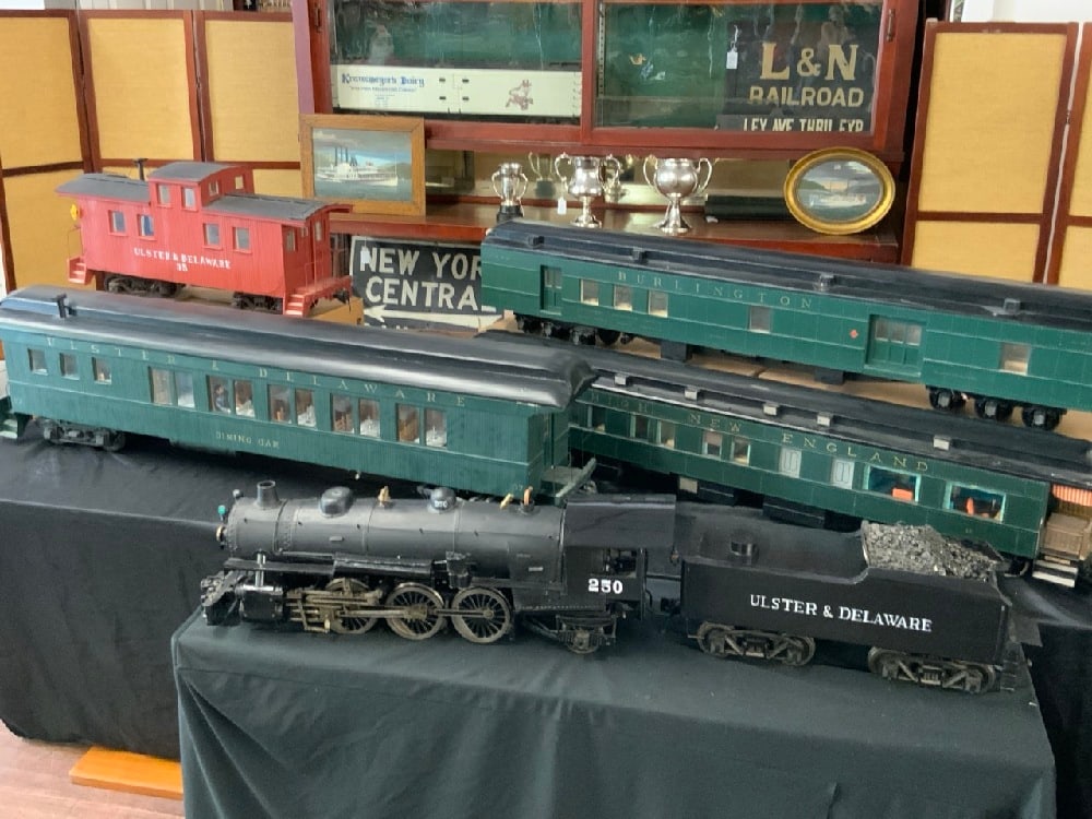 Joe Krajicek Ulster & Delaware Six Piece Large Scale Train Set- Live Steam: Ulster & Delaware Railroad Six Piece Large Scale Train Model Set. Hand Crafted by Joe Krajicek. Lighted cars with intricate detail and mahogany paneling. Dimensions: Engine 250, 35” L x 11&rdquo
