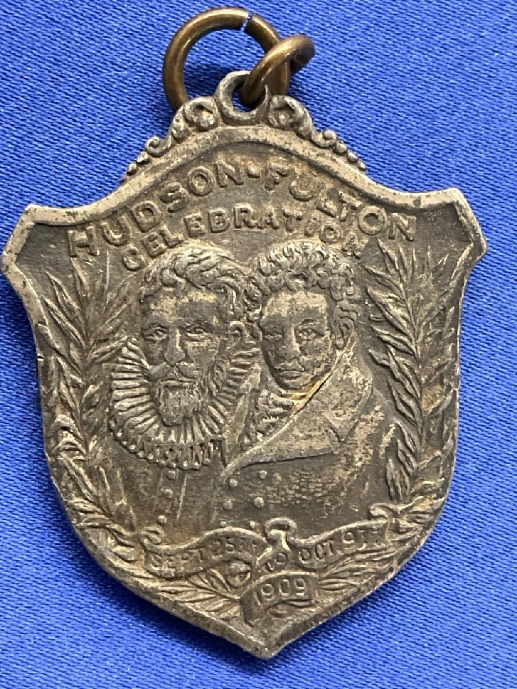 1909 Hudson Fulton Celebration Badge Shaped Medal: 1909 Hudson Fulton Celebration New York to Albany Robert Fulton and Henry Hudson with Clermont and Half Moon. Dimensions: 1 1/2” x 1 1/4”