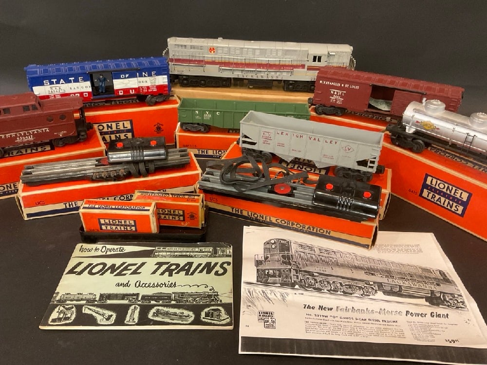 Lionel Train Group: Lionel Train Lot Including: 362-78 Barrels, UCS “ O” Gauge Remote Control Track Set (2) , No. 6464, No. 6415, No. 6462, No. 6456, No. 6417, No. 3494-275, Lackawanna 2321. In Original Boxes