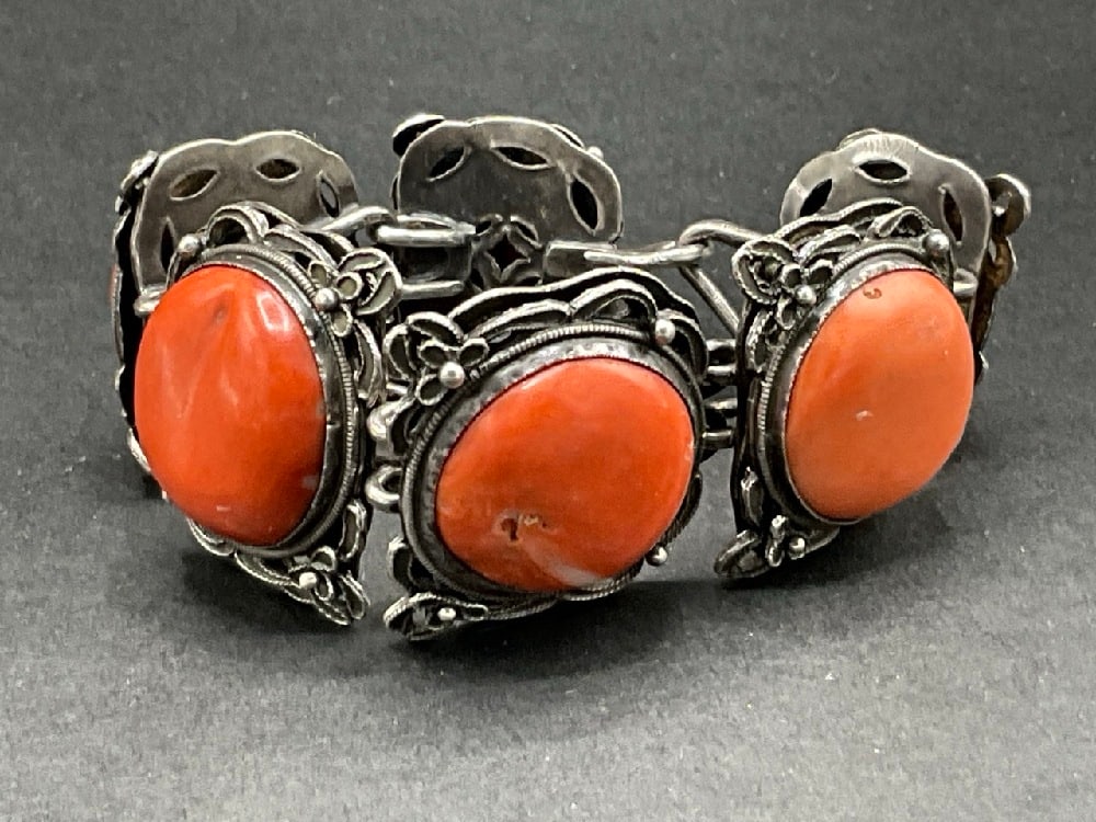Tibetan Silver and Coral Bracelet: Tibetan Silver and Coral Bracelet. Dimensions: 7” x 1 1/4” Total weight: 2.99 Troy ounces