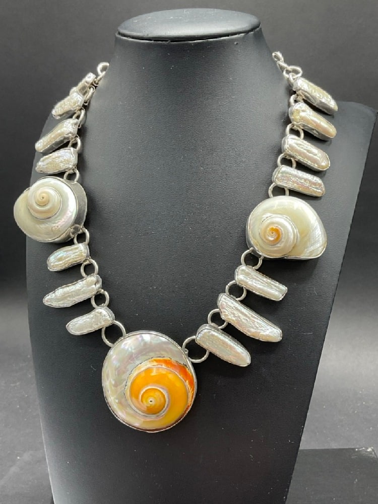 Sterling Silver Seashell Necklace: Sterling Silver Sea Seashell and Mother-of-Pearl Necklace. Dimensions: 16" and 2" largest size of shell.