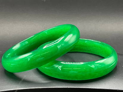 Pair of Chinese Jade Green Bangle Bracelets: A Pair, Vintage Chinese Vivid Green Jade Bangle Bracelets. 1st Half 20th Century. Dimensions: 3 1/2”