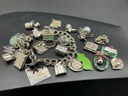 Sterling Silver Charm Bracelet and Charms: Compiled Sterling Silver Charm Bracelet and Charms. Total weight: 70.11 grams.