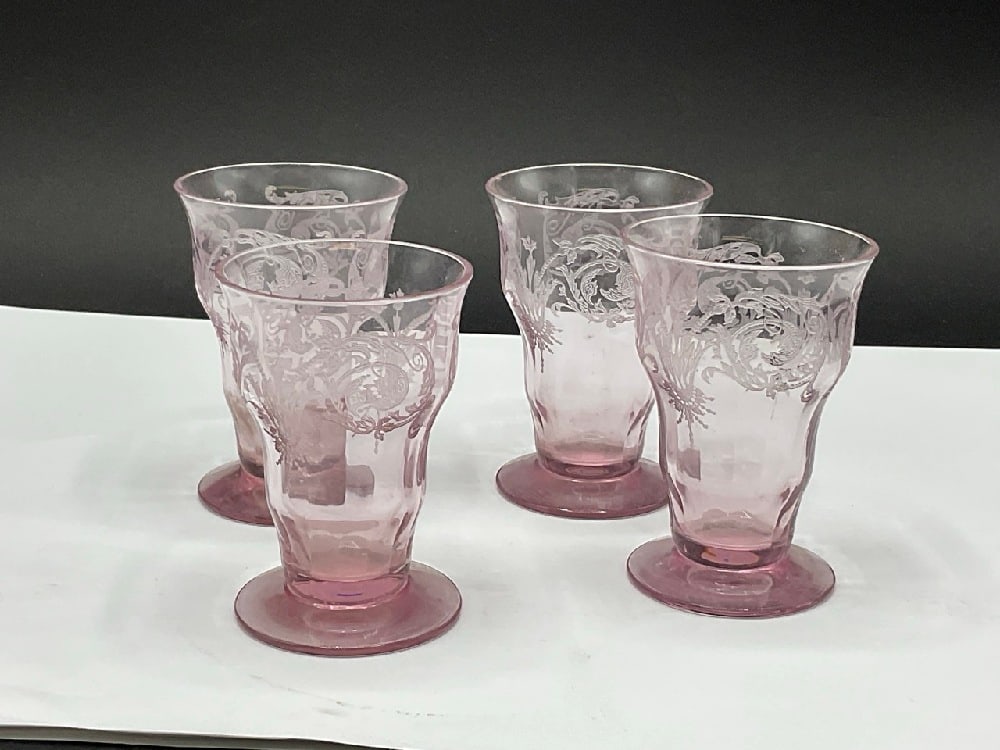 Four (4) Depression Glass Amethyst Juice Glasses: Four (4) Elegant Central Glass Works Footed Tumbler Juice Glasses. Amethyst Color. One having slight nip and one glass appears shaved down from others. Please see photograph preview.Dimensions: 3 1/4&