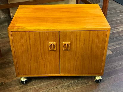 Danish Modern Two Door Teakwood Cabinet on Wheels: Danish Modern Two Door Teakwood Cabinet on Castor Wheels.Dimensions: 17” x 24” x 16”
