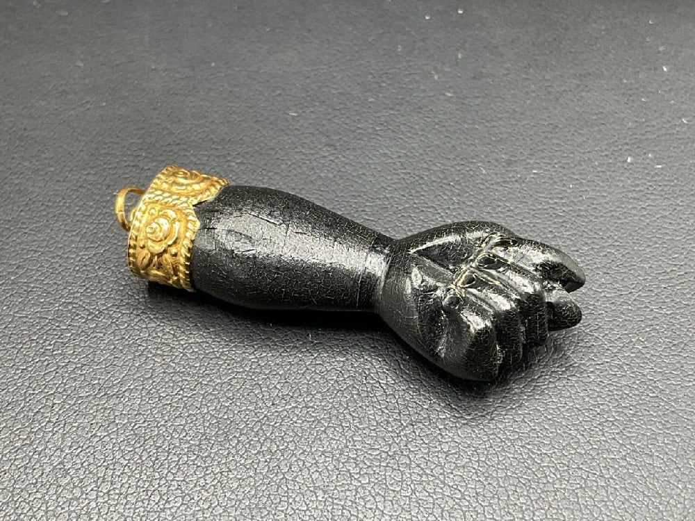 18K Ebonized Wood Blackamoor Jewelry Hand Pendant: Antique ebonized wood blackamoor hand pendant with 18K tested gold cap and bail. Dimensions: 1 3/4”