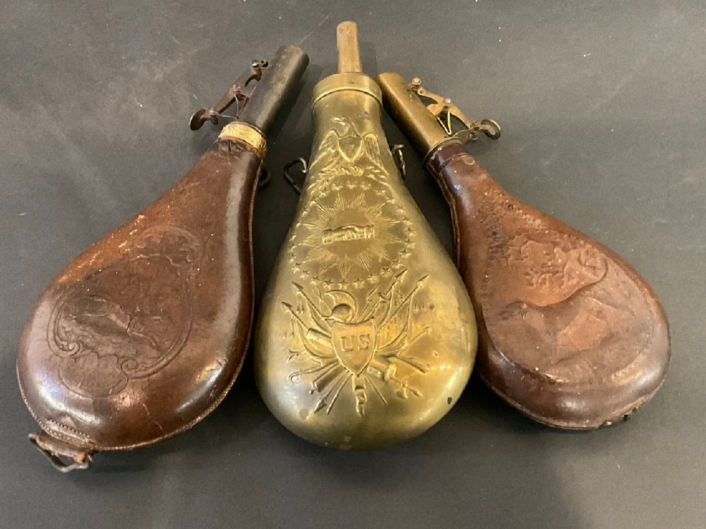 Three (3) Antique Civil War Style Powder Flasks: Three (3) Antique Civil War Style Powder Flasks.Dimensions: lg - 9” Sm - 8 1/2”.The peace flask is a reproduction. Made in Italy. Thanks for your interest.